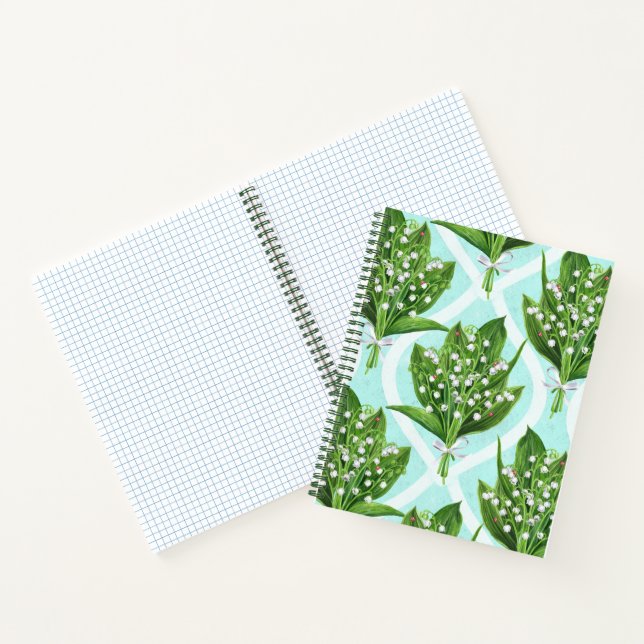 Bouquet of lily of the valley flowers on blue notebook (Inside)