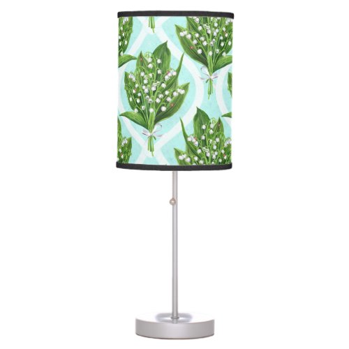 Bouquet of lily of the valley flowers on blue table lamp