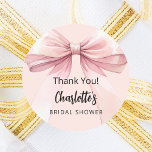 Bow blush pink thank you Bridal Shower Classic Round Sticker<br><div class="desc">A soft,  blush pink colored background. Decorated with a large bow.  Personalize and add the bride's name. Black handwritten style script.

Text: Thank You!</div>