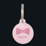 Bow Pet ID Tag<br><div class="desc">Adorn your beloved pet with the essence of elegance and charm with this Bow Pet ID Tag. Embracing a delicate pinkish hue, this tag is graced with a graceful bow illustration that radiates a subtle yet unmistakable sophistication. The addition of your pet’s name in a soft, complementary font completes this...</div>