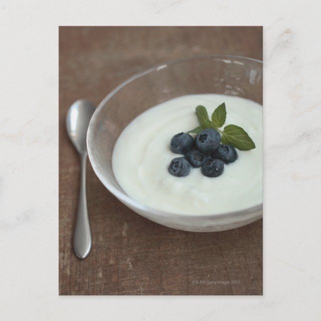 Bowl of yoghurt with blueberry on table postcard (Front)