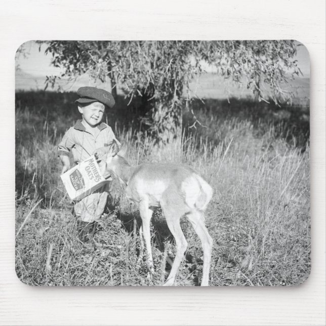 Boy feeding antelope by hand mouse pad (Front)