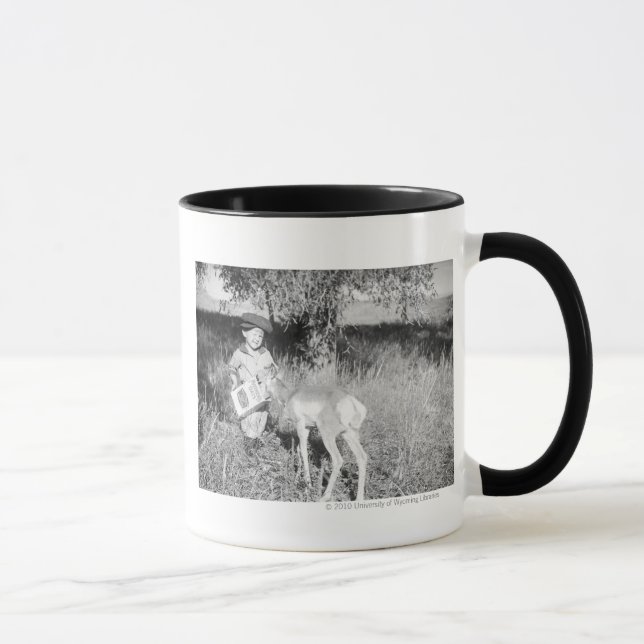 Boy feeding antelope by hand mug (Right)