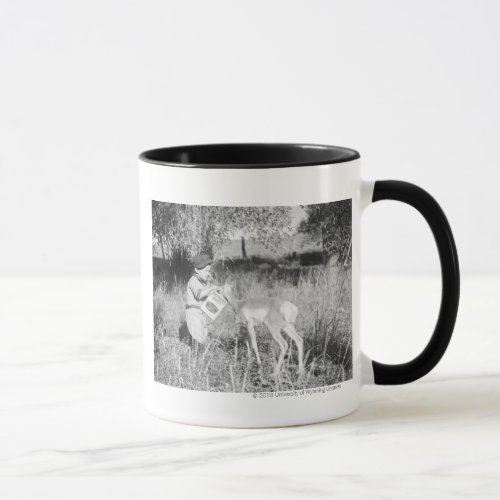 Boy feeding antelope mug