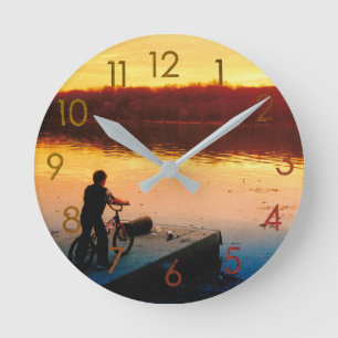 Boy on Bicycle at Sunset Wall Clock
