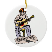 Boy playing acoustic guitar with sheet music