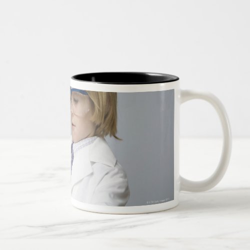 Boy pouring liquid into beaker Two_Tone coffee mug