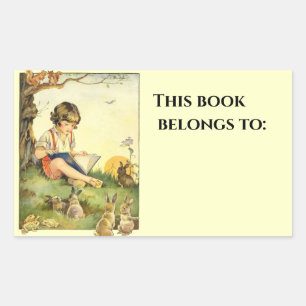 Boy reading under tree with rabbits rectangular sticker