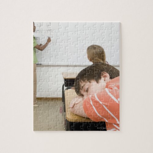 Boy sleeping on desk in classroom jigsaw puzzle