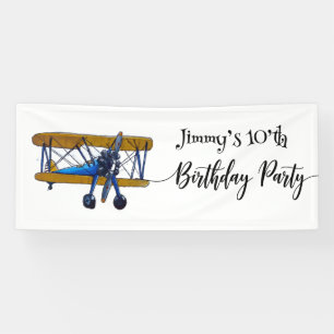 Boys birthday party with blue and yellow biplane banner