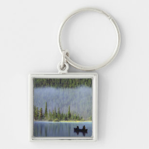 Boys fishing from canoe with mist in keychain