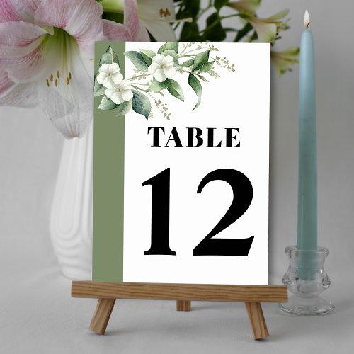 Branch with greenery and white flowers wedding table number