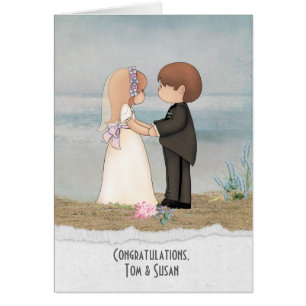 bride and groom on beach sand with specific name cards