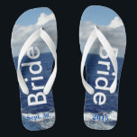 Bride Ocean Waves Blue Sky Flip Flops<br><div class="desc">One-of-a-kind Bride flip flops custom designed. Pretty Blue Sky with Fluffy White Clouds, Blue Sea and White Foam Ocean Waves. Unisex Flip Flops with Bride written in a light silver text, and Date of Marriage in blue text. PERSONALIZE with your Wedding DATE (or delete text). Shown with Wide White Straps...</div>