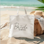 Bride Personalized Bachelorette | Custom Name Tote Bag<br><div class="desc">Celebrate the bride in style with this elegant and minimal Bride tote bag, personalized with her name underneath a modern script and heart design. It’s the perfect carry-all for bachelorette party favors, bridal shower essentials, or a thoughtful gift for the future Mrs. Lightweight yet sturdy, this cotton tote is ideal...</div>