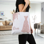Bride rose gold dress name tote bag<br><div class="desc">Modern and trendy faux rose gold drips,  an elegant dress on a stylish white background.  Text with the Word: Bride written in a dark rose gold hand lettered style script. Perfect as a gift for the bride to be!</div>