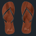 Bride Wedding Day Rustic Wood Look Beach Honeymoon Flip Flops<br><div class="desc">Rustic wood look bride flip flop thong sandals perfect for beach weddings- Reads Bride in elegant style, pastel pink letters at the bottom. Elegant, rich mahogany wood look woodgrain pattern background. Note: Wood is printed image. Rustic wedding favors for bridal party members. Just change text templates to create your own...</div>