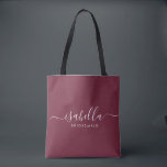 Bridesmaid Gift Burgundy Personalized Tote Bag<br><div class="desc">This Bridesmaid accessory bag features a handwritten white script typography with swashes on a burgundy background. Present your bridesmaids with a tote bag for small items traditionally presented at the rehearsal dinner,  for use in the early morning before the wedding.</div>
