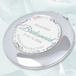 Bridesmaid Gift Elegant Teal & Silver Lace Compact Mirror<br><div class="desc">These compact mirrors are designed to give as favors to the bridesmaids in your wedding party. They feature a simple yet elegant design with a white background, teal or turquoise colored script lettering, and a silver gray faux foil floral lace border. Perfect way to thank your bridesmaids for being a...</div>