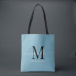 Bridesmaid Gift White Black Monogram Dusty Blue Tote Bag<br><div class="desc">This Bridesmaid tote bag features a handwritten white and black script typography monogram with swashes on a dusty blue background. Present your bridesmaids with a tote for carrying items the day of the wedding,  and traditionally presented at the rehearsal dinner or before.</div>