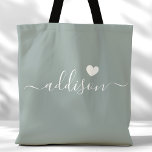 Bridesmaid Modern Script Heart Sage Green Tote Bag<br><div class="desc">This chic tote bag features a beautiful Sage Green background adorned with a modern script font and a delicate heart design. The soft, elegant color and sophisticated typography make it an ideal accessory for bridesmaids or anyone who loves stylish and trendy designs. Perfect for carrying essentials, this tote bag adds...</div>