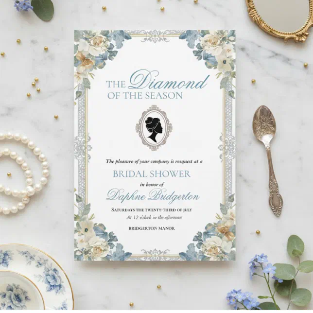 A wedding bridal shower invitation inspired by the Bridgerton books, sitting on a marble table surrounded by China teacups, forget-me-not flowers, and pearls.