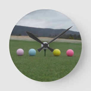 bright colored Golf Balls on a mountain Round Clock