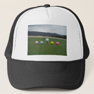 bright colored Golf Balls on a mountain Trucker Hat