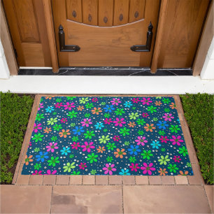 Bright multi-colored chamomile flowers on a blue doormat