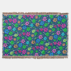 Bright multi-colored chamomile flowers on a blue  throw blanket