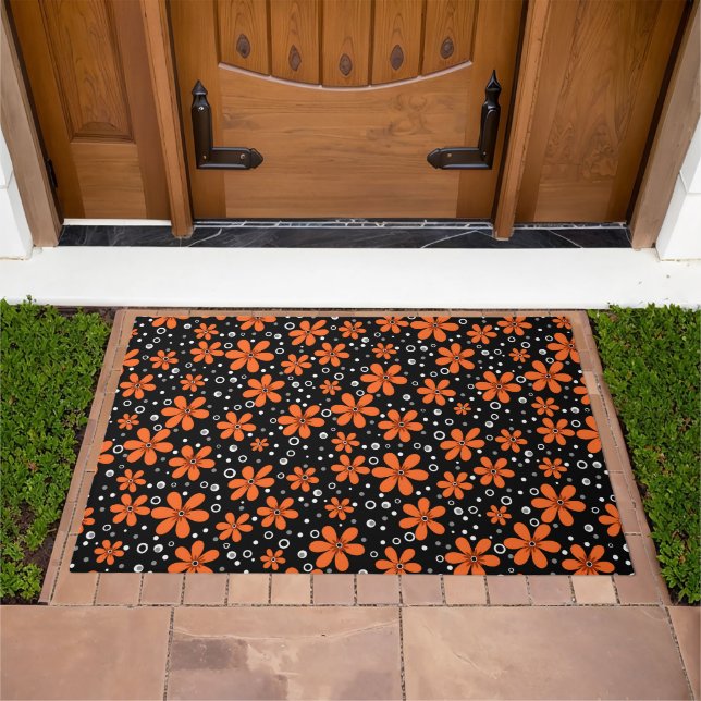 Bright orange flowers on a black background with w doormat (Outdoor)