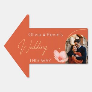 Bright orange wedding "this way" arrow sign