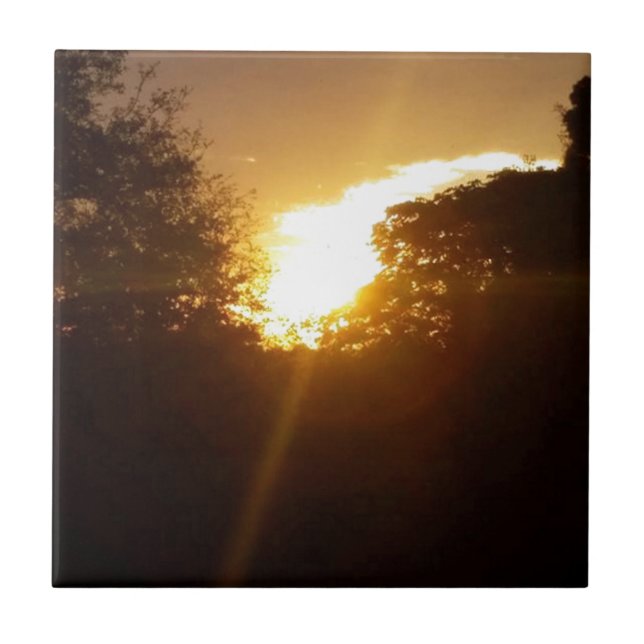 Brilliant sunrise over the trees ceramic tile (Front)
