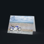 Brother, a birthday card with a motor bike<br><div class="desc">A blue motor cycle standing on a beach with fluffy clouds in the sky. Happy Birthday written in rock reflected in the water lying on the sand.</div>