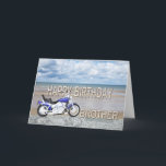 Brother, a birthday card with a motor bike<br><div class="desc">A blue motor cycle standing on a beach with fluffy clouds in the sky. Happy Birthday written in rock reflected in the water lying on the sand.</div>