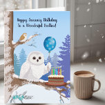 Brother Happy January Birthday Snowy Owl Card<br><div class="desc">This charming January birthday card features a beautiful Snowy Owl holding a snowflake balloon beside a rich chocolate birthday cake, creating a fun and cozy winter scene just right for your brother. In the background, a small Barn Owl peeks out from the snowy setting, adding a playful touch of nature...</div>