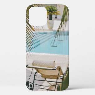 Brown and black armchair beside swimming pool in t iPhone 12 case