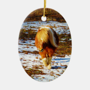 Brown and cream miniature horse in the snow. ceramic ornament