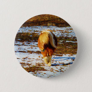 Brown and cream miniature horse in the snow. pinback button
