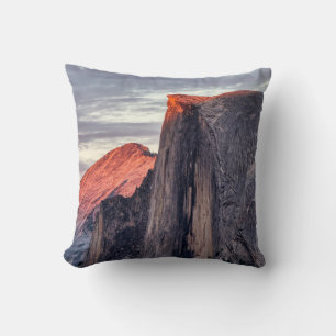 BROWN AND GRAY ROCK FORMATION UNDER GRAY CLOUDS THROW PILLOW