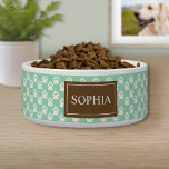 Brown And Mint Green Dog Paws With Pet's Name Bowl<br><div class="desc">This pet bowl features a pattern of white dog paw prints on a mint green background color. There is also a brown banner with a customizable text area for the name of your pet. The beige color can be changed to any other color under customization.</div>