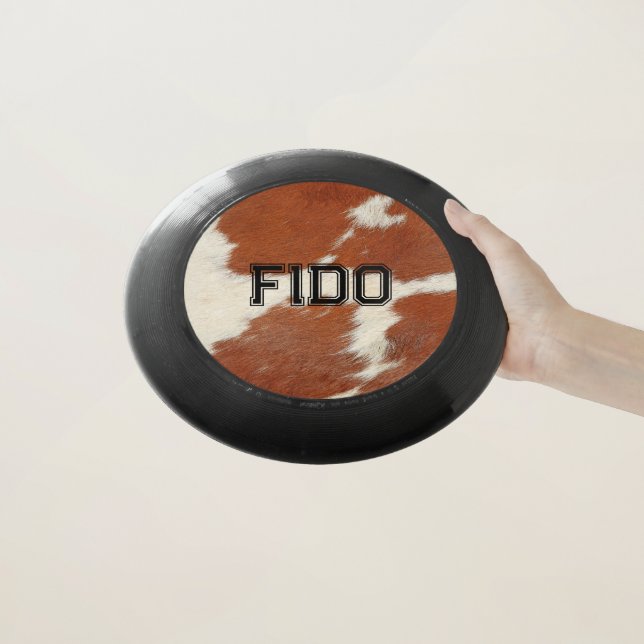 Brown and white cowhide texture Wham-O frisbee (In Hand)
