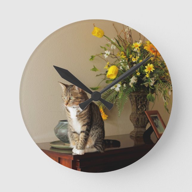 Brown black Tabby cat Sitting on piano flowers Round Clock (Front)