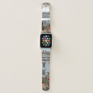 BROWN BRICKED HOUSE NEAR RED FLOWERS APPLE WATCH BAND