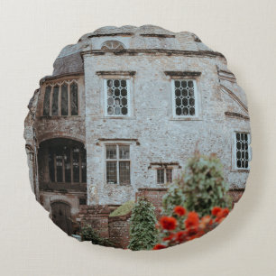 BROWN BRICKED HOUSE NEAR RED FLOWERS ROUND PILLOW