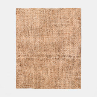 Brown burlap laying on white sheet. Abstract backg Fleece Blanket