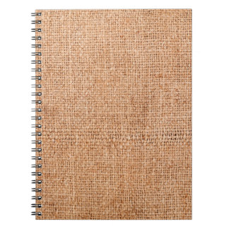 Brown burlap laying on white sheet. Abstract backg Notebook