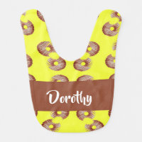 Brown donuts on yellow baby bib