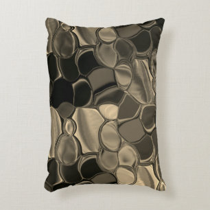 Brown or coppery bits, circles and rounded shapes accent pillow