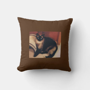 Brown throw pillow with Siamese cat design.